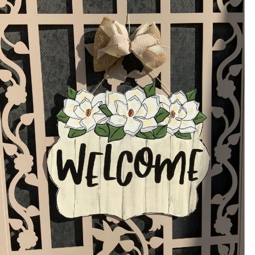 Hand painted welcome sign with magnolia floweres